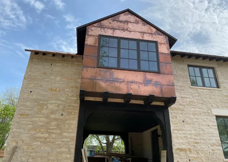 Copper metal panel facade on a stone building for Metal Roof Coating in Vernon